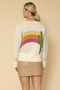 Miss Sparkling cactus rainbow knit cardigan displayed on a hanger, featuring colorful cactus and rainbow patterns in soft knit fabric.