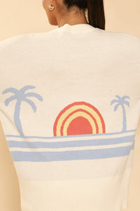 Miss Sparkling ocean sunset knit cardigan displayed on a hanger, featuring a soft, colorful ocean sunset pattern and cozy knit texture.