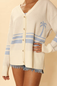Miss Sparkling ocean sunset knit cardigan displayed on a model, showcasing its soft fabric and vibrant sunset-inspired colors.