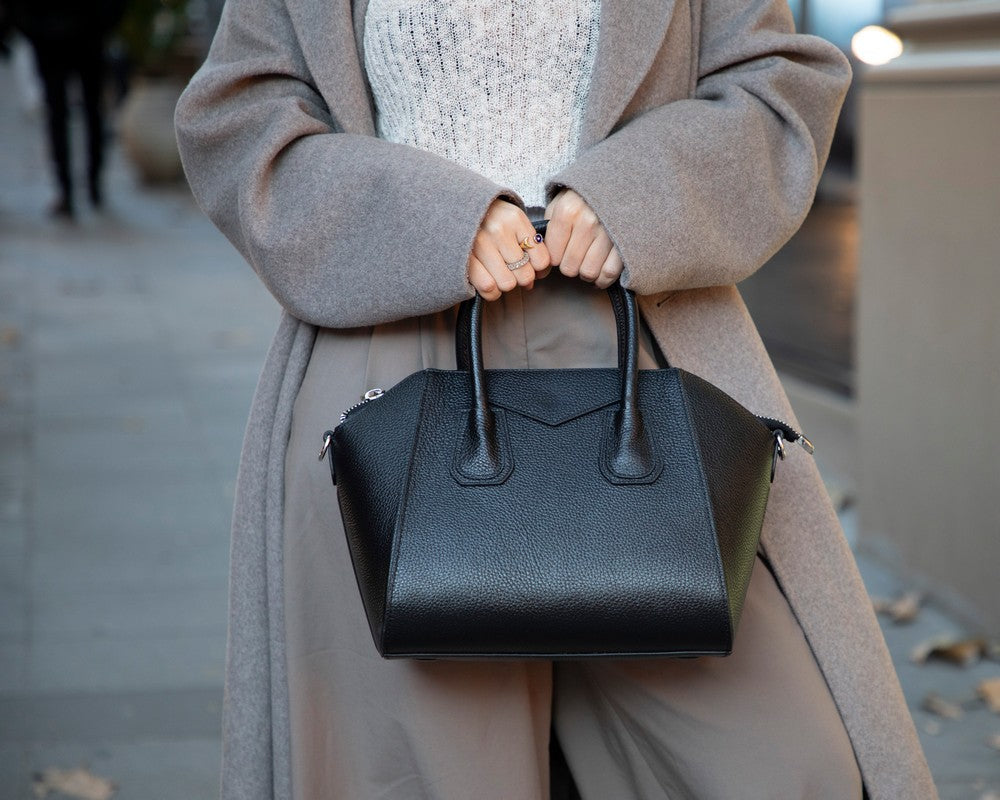 Black Mizuri Leather Lorenza women's medium leather bag with top handles and sleek design, perfect for everyday use.