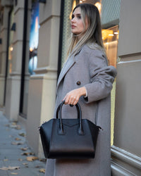 Black Mizuri Leather Lorenza Women's Bag, medium-sized leather handbag with stylish design and adjustable strap.