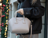 Black Mizuri Leather Lorenza women's medium leather bag with sleek design and sturdy handles.