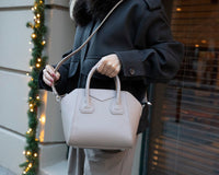 Black Mizuri Leather Lorenza Women's Bag in medium size with sleek leather design and top handles.
