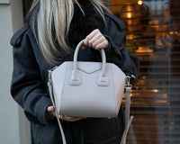 Black Lorenza leather women's bag by Mizuri Leather, medium-sized with sleek design and top handles.
