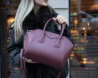 Black Mizuri Leather Lorenza medium women's bag with sleek leather design and top handles, perfect for everyday use.
