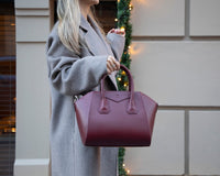 Black Mizuri Leather Lorenza Women's Bag, medium-sized leather handbag with sleek design and sturdy handles.
