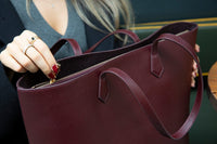 Black Mizuri Leather Solea Women's Bag made of genuine leather with a sleek, stylish design and sturdy handles.