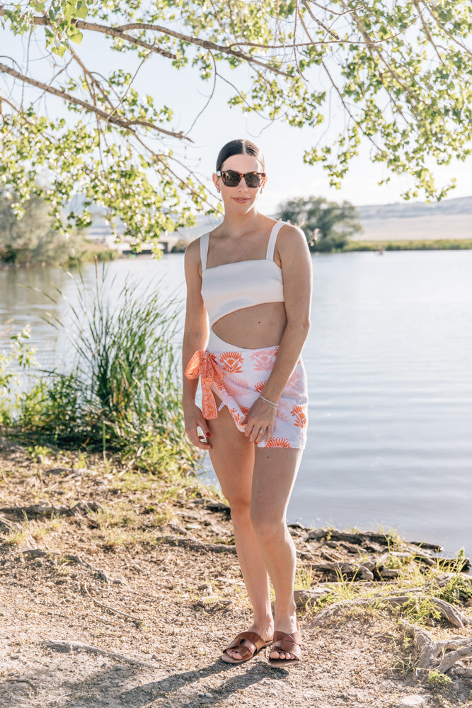 Orange Modafleur The Lotus Sarong, lightweight clothing with floral pattern, displayed folded on a neutral background.
