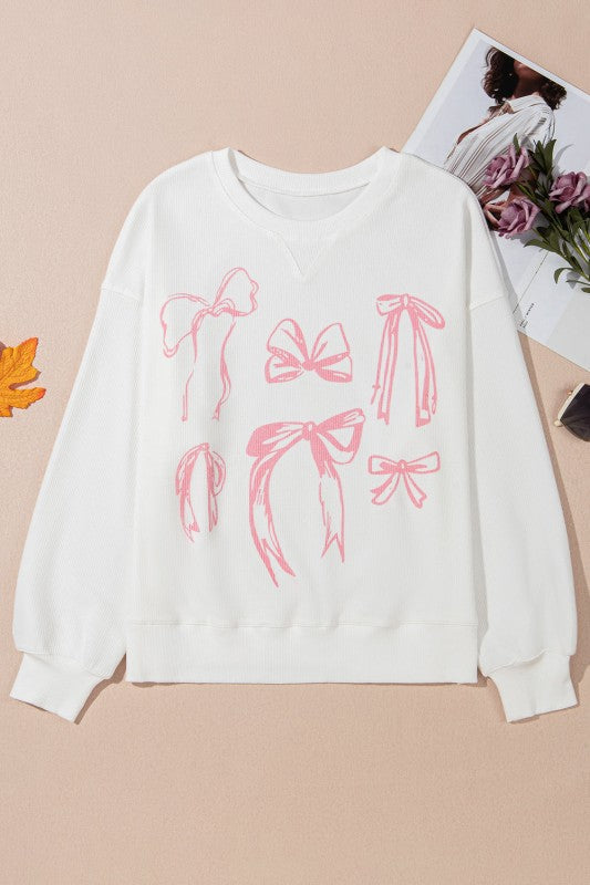 My Pampered Life Seattle Bow long sleeve crewneck top in soft fabric, featuring a stylish bow detail on the chest.