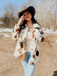 My Pampered Life Seattle Miss Sparkling cow print sherpa jacket in regular size, cozy and stylish with a black and white cow pattern.