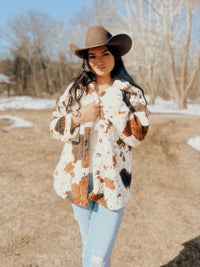 Miss Sparkling cow print sherpa jacket from My Pampered Life Seattle, shown in a cozy, plush sherpa fabric with a stylish cow pattern.