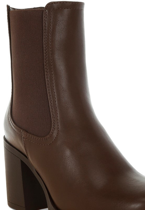 Black faux leather Chelsea boots from My Pampered Life Seattle featuring elastic side panels and a sleek, modern design.