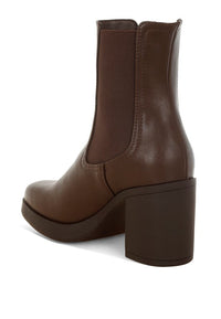 Pair of black Scuala Faux Leather Chelsea Boots by My Pampered Life Seattle, featuring elastic side panels and sleek ankle design.