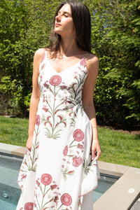 Red vine cross-back maxi dress from nibimtk.com, flowing fabric with stylish back detail and vibrant floral pattern.