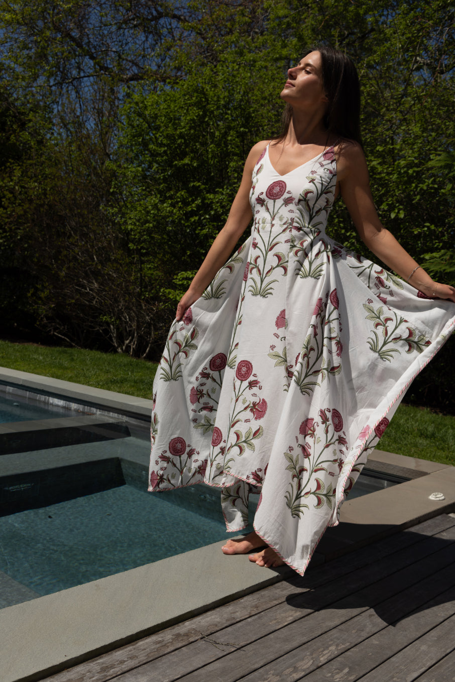 Red vine cross-back maxi dress from nibimtk.com, flowing fabric with stylish back design, perfect for elegant summer occasions.