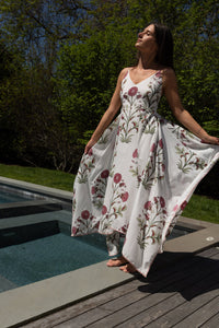 Red vine cross-back maxi dress from nibimtk.com, flowing fabric with stylish back design, perfect for elegant summer occasions.