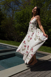 Red vine cross-back maxi dress from nibimtk.com, flowing fabric with stylish back design, perfect for elegant summer occasions.