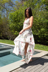Red vine cross-back maxi dress from nibimtk.com, flowing fabric with stylish back detail and vibrant floral pattern.