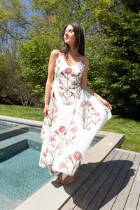 Red vine cross-back maxi dress from nibimtk.com, flowing fabric, sleeveless design, and elegant back detail.