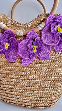 NIKOZA Goddess in Lilac Straw Beach Bag with woven design and handles, perfect for summer outings and beach days.