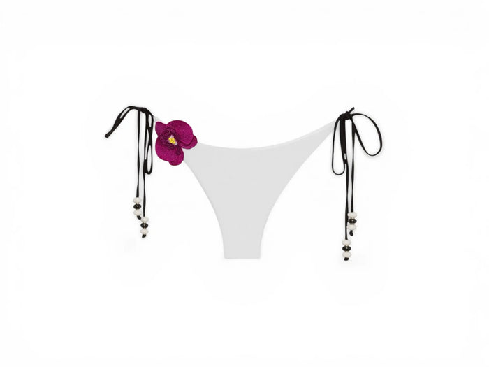 White NIKOZA Lycaste bikini bottom with a sleek, minimal design, shown on a flat lay with smooth fabric and clean edges.