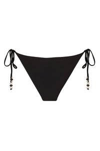 Reversible fuchsia and black Cattleya bikini bottom by NIKOZA with tie sides, shown on a model.