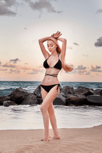 Reversible fuchsia and black Cattleya bikini bottom by NIKOZA with tie-side design and comfortable fit.
