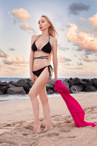 Reversible Cattleya Bottom bikini by NIKOZA in fuchsia and black with tie sides, shown on a model.