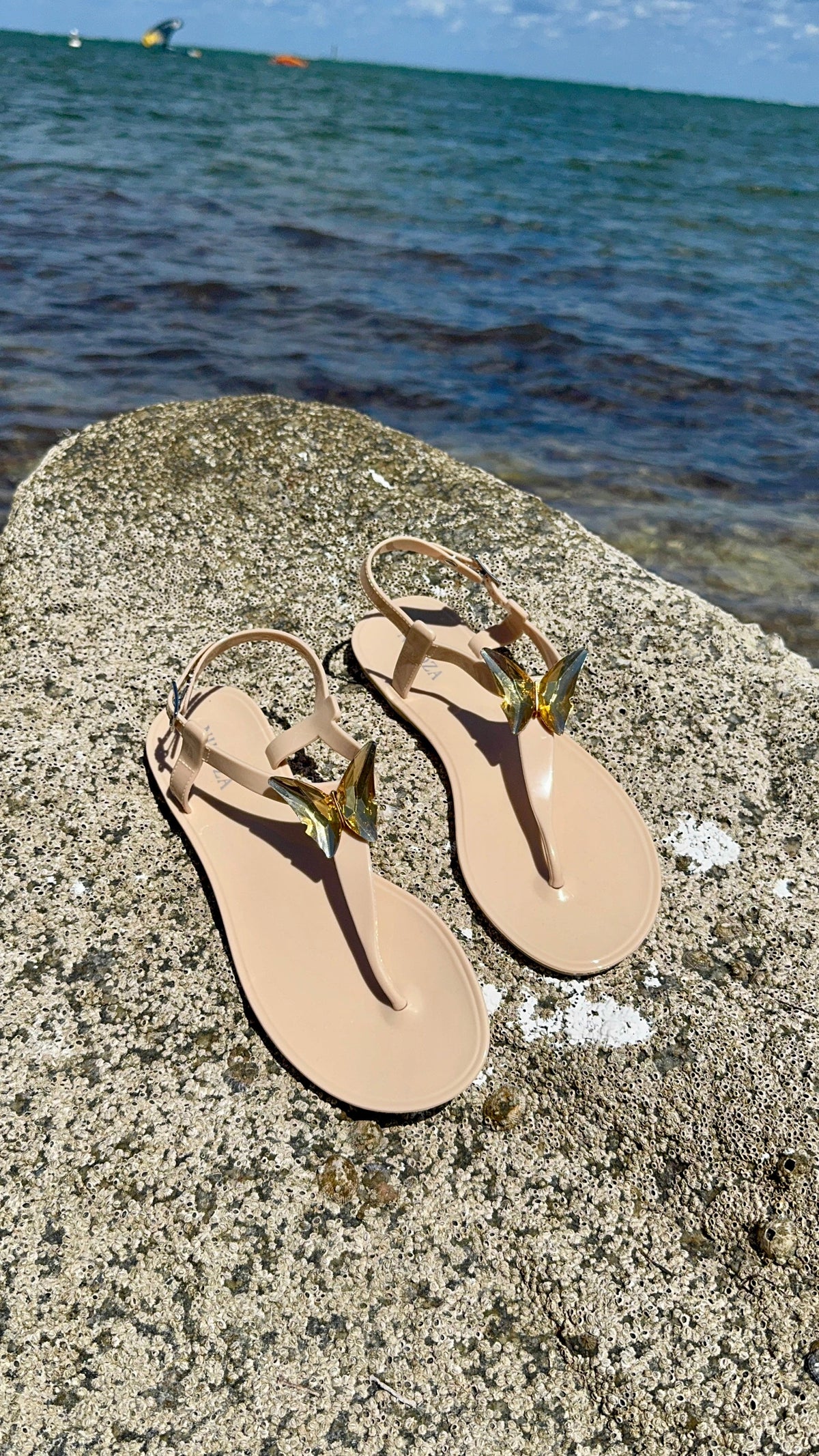NIKOZA ALIANA clear gel beach sandals with transparent straps and flat sole, perfect for casual summer wear.