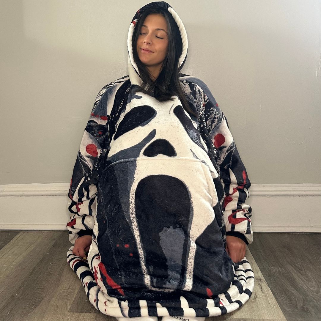 Ghost Face horror wearable blanket hoodie by Olm Collectibles, showing a cozy, character-themed blanket hoodie for kids and adults.