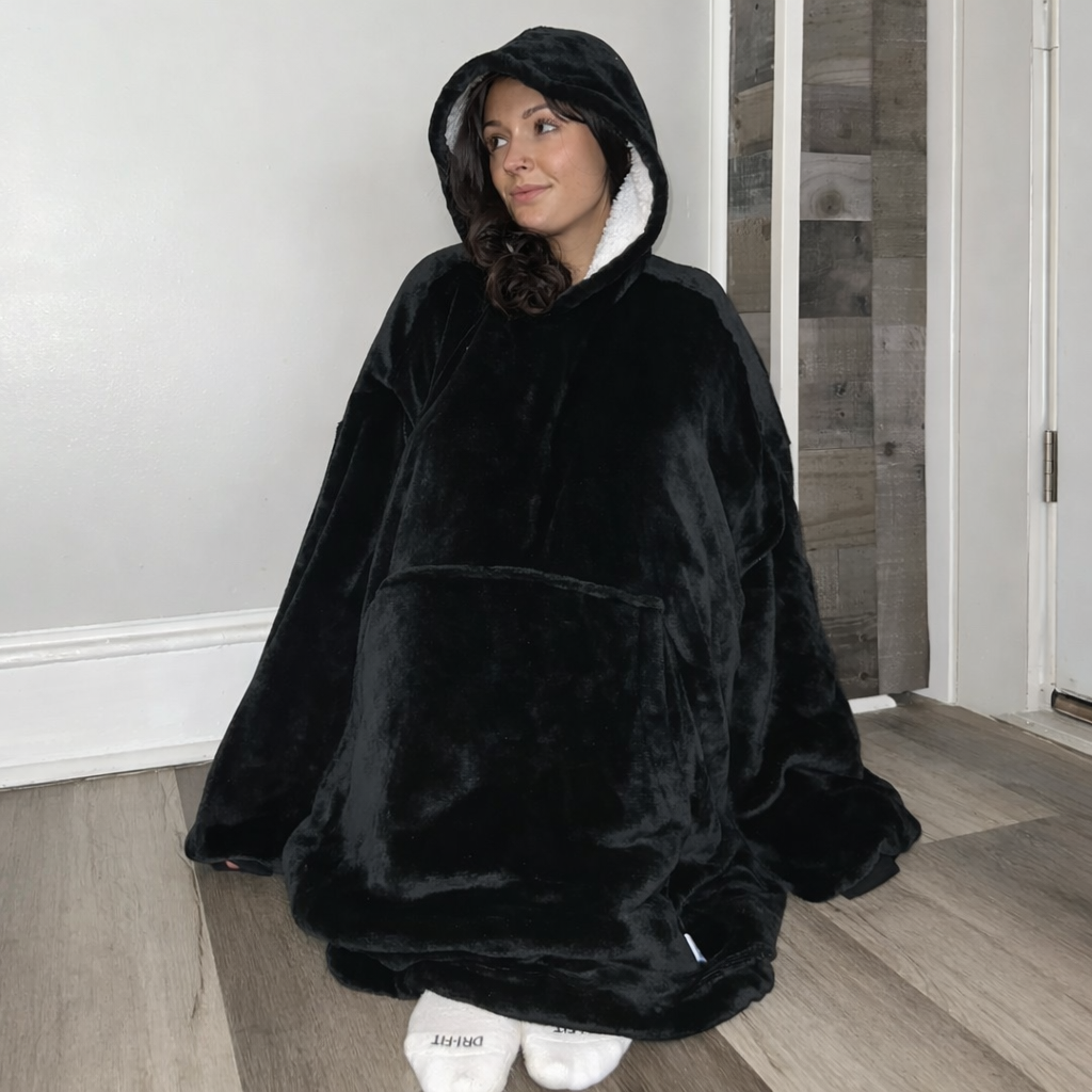 Black wearable Sherpa blanket hoodie by Olm Collectibles, oversized for kids and adults, cozy and warm with soft fleece material.