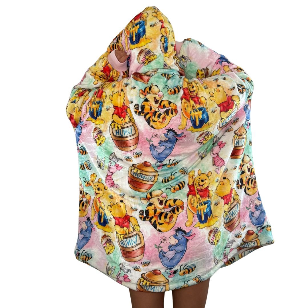 Olm Collectibles Winnie the Pooh & Friends wearable blanket hoodie for kids and adults, featuring soft, cozy fabric with character print.