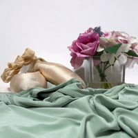Light green pistachio ballet wrap skirt by oodelooo Ballet Wear, in demi length, shown with flowing fabric and elegant design.