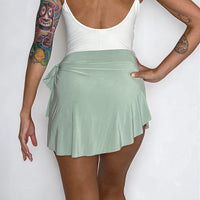 Light green pistachio ballet wrap skirt by oodelooo Ballet Wear, demi-length, soft fabric, shown on a model.