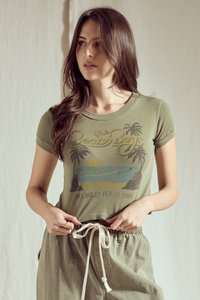 People of Leisure California Dreamin' baby tee top featuring a vintage beach scene and retro design on soft cotton fabric.