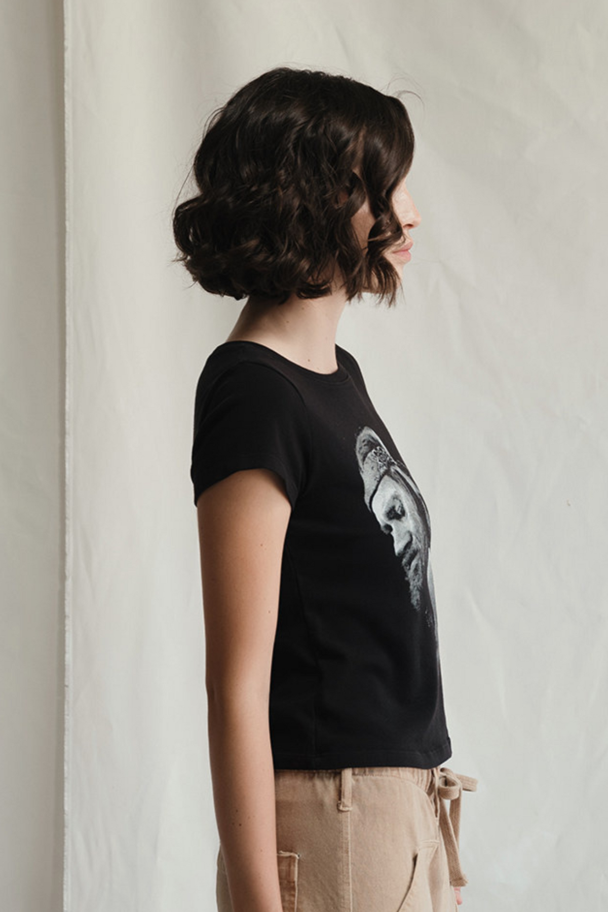 People of Leisure Willie Nelson Just Breathe tee top, casual black t-shirt with white graphic print, short sleeves, and round neckline.