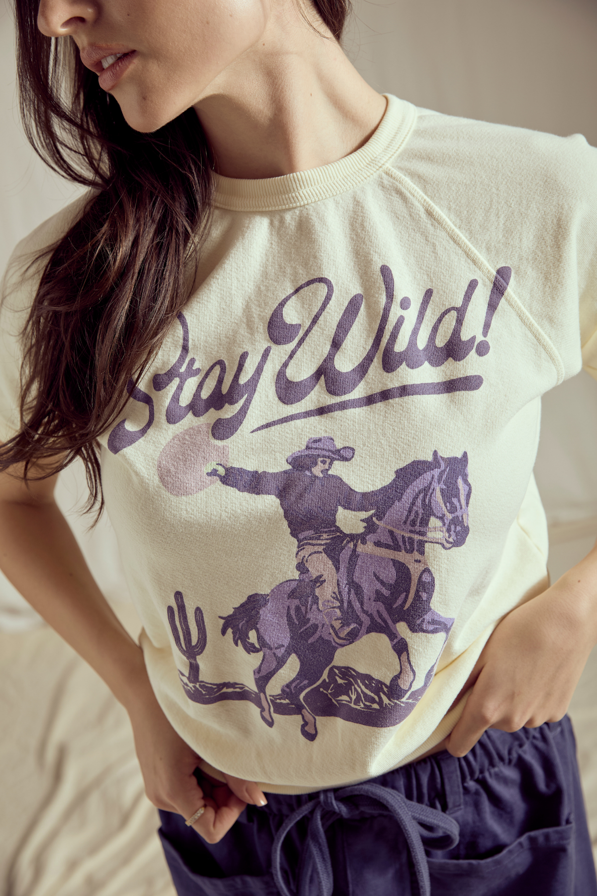 Women’s Stay Wild Raglan Summer Top by People of Leisure, featuring a casual, lightweight design with a relaxed fit and short sleeves.