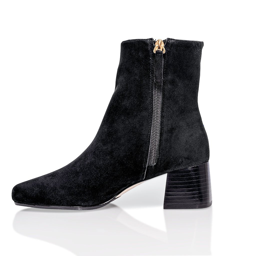 Black suede Arina Dress Ankle Bootie with a block heel by Joan Oloff Shoes, featuring a stylish and comfortable design.