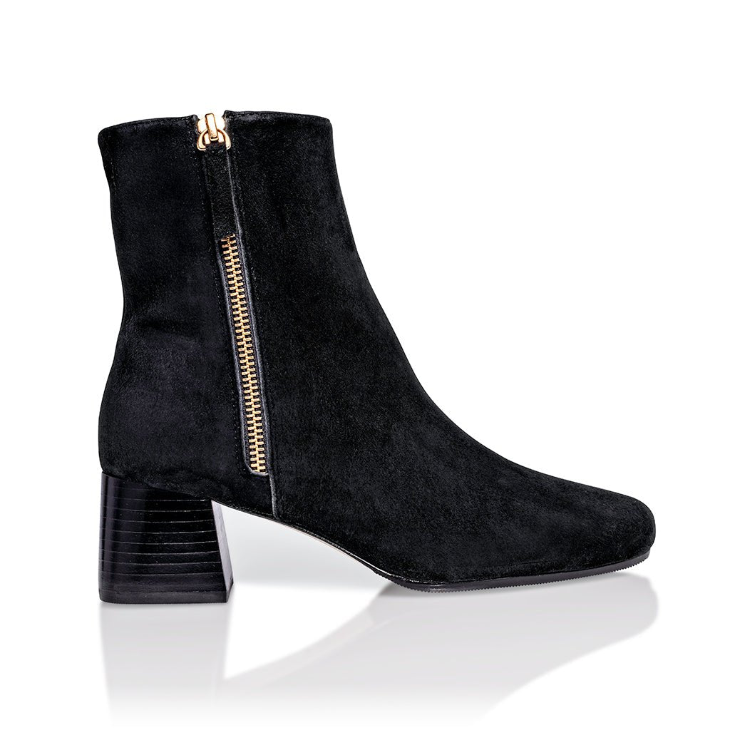Black suede Arina ankle bootie with a block heel from Joan Oloff Shoes, showcasing the stylish design and textured material.