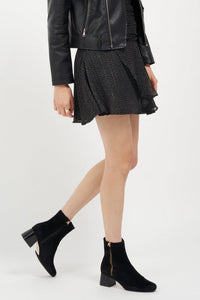 Black suede Arina ankle bootie with a block heel from Joan Oloff Shoes, showcasing its stylish design and textured material.