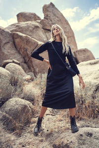 Black slip dress by Profile NYC, lightweight fabric, sleeveless design, and subtle side slit, perfect for elegant occasions.