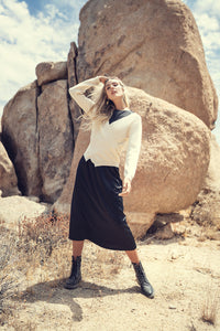 Elegant black slip dress by Profile NYC featuring a sleek, smooth fabric and a flattering fit.