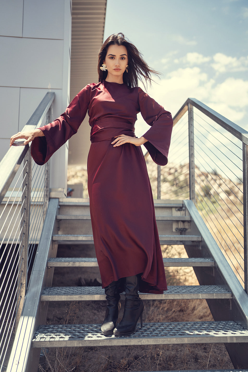 Black bell sleeve dress by profile-nyc featuring a flattering fit and stylish bell-shaped sleeves.