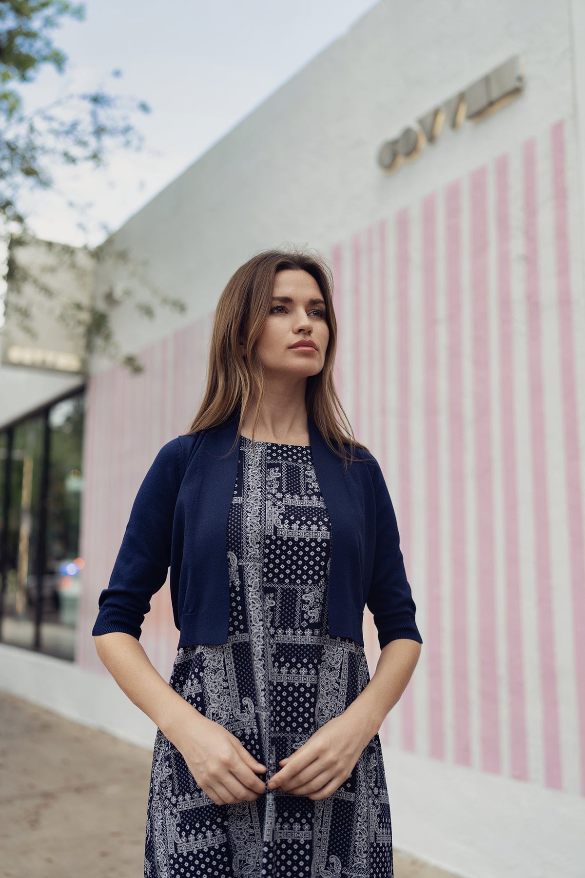 Navy paisley jumper dress by profile-nyc, featuring a stylish pattern and comfortable fit, displayed on a hanger.