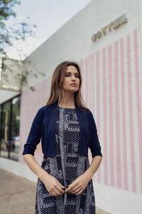 Navy paisley jumper dress by profile-nyc, featuring a stylish pattern and comfortable fit, displayed on a hanger.