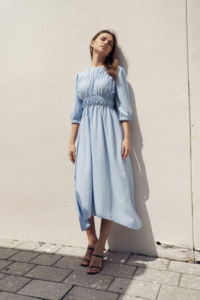 Sky smocking dress by Profile NYC featuring a stylish, fitted dress with intricate smocking details and a flattering silhouette.