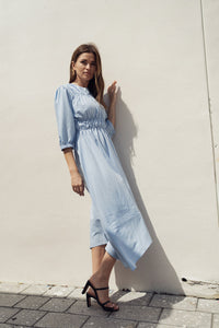 Sky smocking dress by profile-nyc, featuring a stylish, fitted design with smocked fabric and elegant shoulder straps.