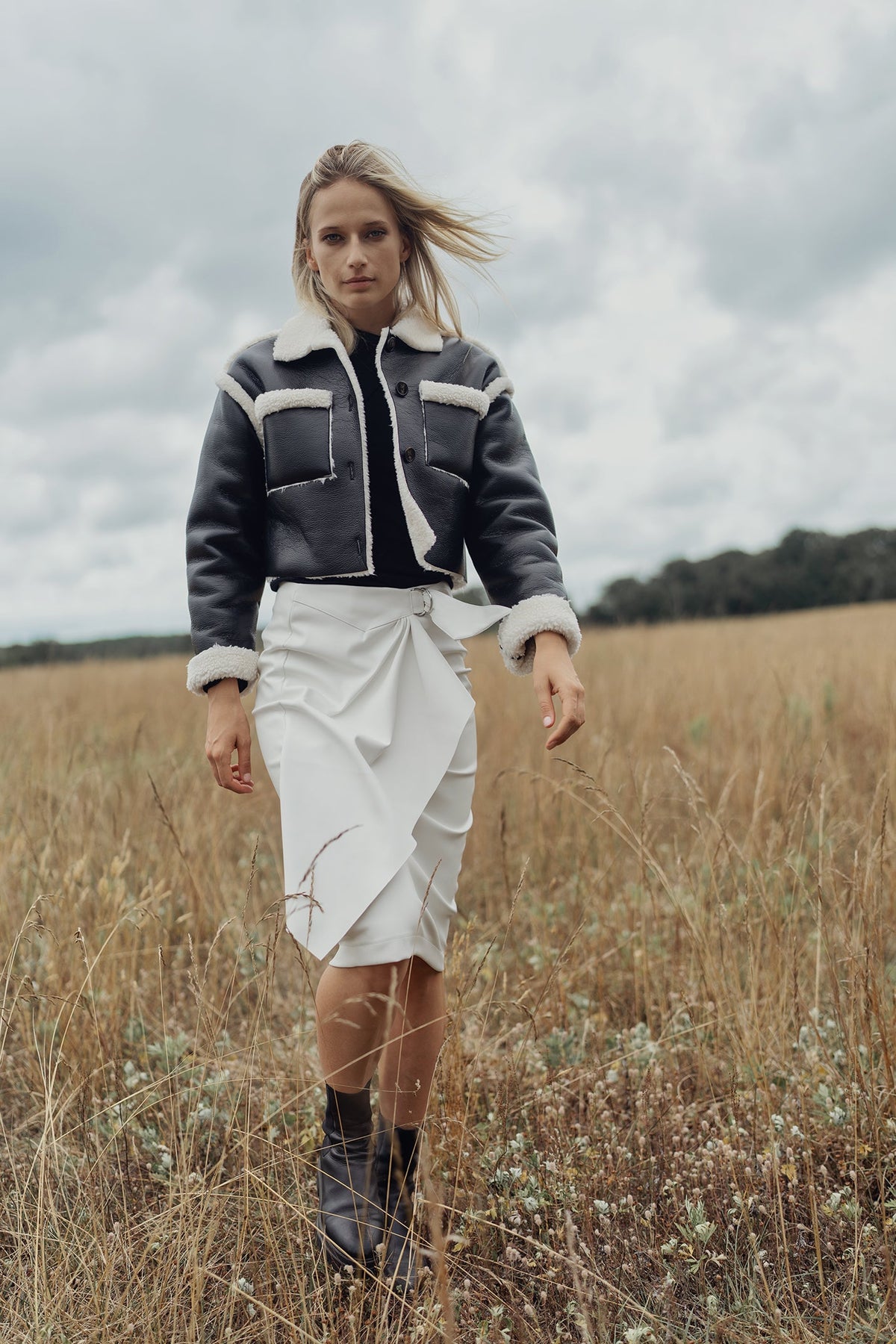 Black leather sherpa jacket by Profile NYC featuring a cozy shearling lining and classic design, shown on a mannequin.
