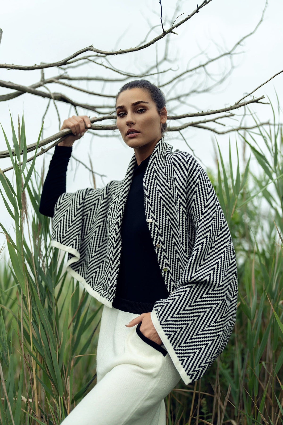 Soft knit shawl by profile-nyc, draped over a neutral background, showcasing its cozy texture and versatile style.