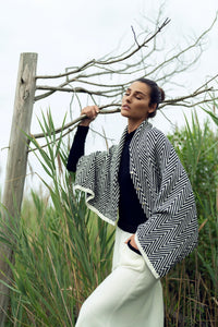 Soft knit shawl by profile-nyc featuring a cozy, textured design, perfect for layering and adding warmth to your outfit.